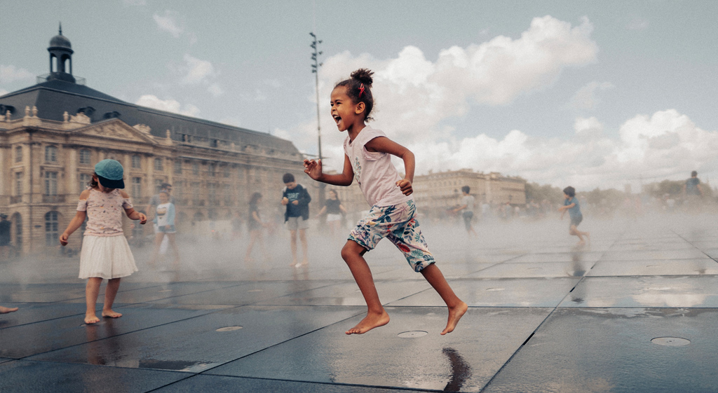 Enfants jouant dans le miroir d'eau de Bordeaux