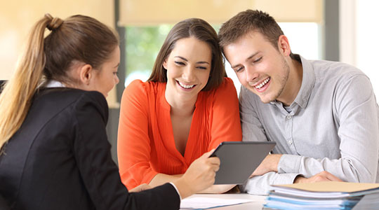 vendeuse présentant les plans d'un bien immobilier